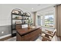 Bright home office featuring wainscoting, large windows, and custom shelving at 313 Canoe Pl, Villa Rica, GA 30180