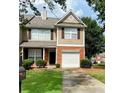 Charming two-story home featuring well-manicured lawn, brick facade, and attached garage at 164 Haven Oak Way, Lawrenceville, GA 30044