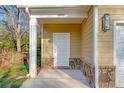 Front entry with stone facade and white door at 6860 Robinson St, Lithonia, GA 30058