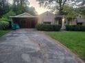 Inviting one-story house with a long driveway and ample greenery at 1767 Thomas St, Decatur, GA 30032