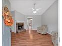 Comfortable living room with a stone fireplace and hardwood flooring at 182 Noah Dr, Rockmart, GA 30153