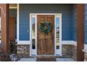 Elegant front door with decorative wreath and stone accents at 117 Pacific Ave, Sharpsburg, GA 30277