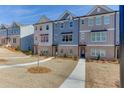 Multi-story townhomes with beautiful exteriors and nicely landscaped front lawns at 1258 Ainsworth Aly # 46, Sugar Hill, GA 30518