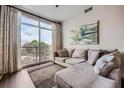 Inviting living room with a comfortable sectional sofa, large windows, and wood-look flooring at 2626 Peachtree Nw Rd # 804, Atlanta, GA 30305