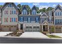 Attractive row of townhomes, each with unique exterior designs and two-car garages at 226 Trecastle Sq # 23, Canton, GA 30114