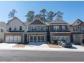 Charming townhomes with well-maintained landscaping and convenient two-car garages at 2882 Cadence Walk Rd, Atlanta, GA 30360