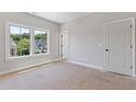 Bright, unfinished bedroom featuring a large window, ample natural light, and a neutral color palette at 230 Trecastle Sq # 25, Canton, GA 30114