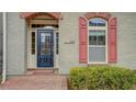 Close-up of house number and entryway with a decorative black door and red brick accents at 319 Barbados Ln, Suwanee, GA 30024