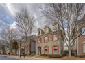 Charming two-story home featuring red shutters and mature trees along the street at 319 Barbados Ln, Suwanee, GA 30024