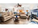 Spacious living room featuring a plush sectional sofa, wood floors, and a charming fireplace at 691 Mount Tabor Rd, Oxford, GA 30054