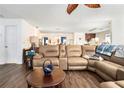 Bright and airy living room boasting hardwood floors, a large sectional sofa, and a ceiling fan at 691 Mount Tabor Rd, Oxford, GA 30054