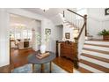 Inviting foyer with hardwood floors and a staircase, leading to a cozy living room at 1602 Windsor Walk, Avondale Estates, GA 30002