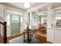 Bright foyer features hardwood floors, staircase, and view of the dining room at 1602 Windsor Walk, Avondale Estates, GA 30002