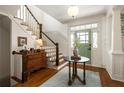 Bright foyer features hardwood floors, staircase, and view of the front door at 1602 Windsor Walk, Avondale Estates, GA 30002