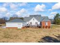 Exterior backyard view with a well-maintained lawn, a patio, and a detached garage at 1650 Old Loganville Rd, Loganville, GA 30052