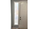 Entryway featuring a frosted glass sidelight window and a white front door with classic paneling at 1666 Hearthstone Way, Jonesboro, GA 30236