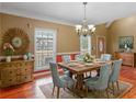 Elegant dining room featuring a stylish chandelier and hardwood floors at 1000 Eddie Craig Dr, Mcdonough, GA 30252
