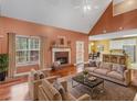 Cozy living room with a fireplace, vaulted ceiling, and comfortable seating at 1000 Eddie Craig Dr, Mcdonough, GA 30252