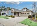 Inviting single-story home with a well-maintained lawn, concrete driveway, and covered front porch at 117 Clover Way, Woodstock, GA 30188