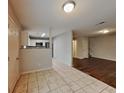 View of the dining room, kitchen with stainless appliances, and hardwood floors into the living room at 1211 Brookstone Rd, Atlanta, GA 30349