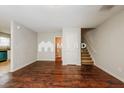 Open living room with hardwood floors, a staircase, and a view into another room at 1211 Brookstone Rd, Atlanta, GA 30349