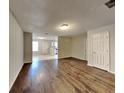 Spacious living room featuring hardwood floors, neutral paint, and entry to the adjacent kitchen at 1211 Brookstone Rd, Atlanta, GA 30349