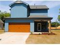 Stylish blue home with a spacious two-car garage and inviting covered patio area at 131 Old Alabama Se Rd, Emerson, GA 30137