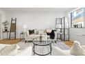 Stylish living room with a modern couch, area rug, and an abundance of natural light at 215 Piedmont Ne Ave # 308, Atlanta, GA 30308