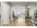 Bright open living room featuring mirrored walls, light wood floors, and neutral decor at 215 Piedmont Ne Ave # 308, Atlanta, GA 30308