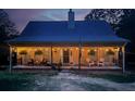 Night view of a cozy home with a welcoming porch adorned with lights and comfortable seating, creating a warm ambiance at 2625 Hendry Ne Ct, Conyers, GA 30012