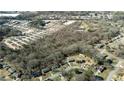 Aerial view showing trees surrounding houses in a residential area near an industrial park at 116 Thornton Dr, Jonesboro, GA 30236