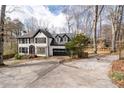 Exterior view of home from driveway showcasing the well manicured lawn and mature trees at 2321 Birdie Ln, Duluth, GA 30096