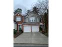 Traditional style townhouse with two-car garage and a brick and siding exterior at 2394 Elkhorn Ter, Duluth, GA 30096