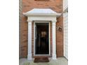 Inviting front door features classic white trim and brick exterior accents at 2394 Elkhorn Ter, Duluth, GA 30096