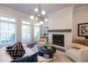 Bright living room featuring a white brick fireplace, large windows, and stylish decor at 608 Goldsmith Ct # 113, Johns Creek, GA 30022