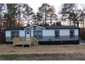 Attractive single-story house showcasing a well-maintained yard, front porch, and gray and white siding at 7382 Knox Bridge Hwy, Canton, GA 30114