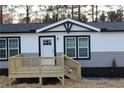 Attractive front entrance with a new wooden deck and stairs at 7382 Knox Bridge Hwy, Canton, GA 30114