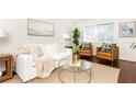 Inviting living room with a white sofa, brown leather chairs, and natural light at 100 Biscayne Nw Dr # 4, Atlanta, GA 30309