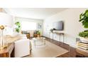 Bright living room with a white sofa, brown leather chairs and a glass coffee table at 100 Biscayne Nw Dr # 4, Atlanta, GA 30309