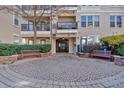 Elegant building entrance featuring secure entry, stone paving, and manicured landscaping at 1850 Cotillion Dr # 4204, Dunwoody, GA 30338