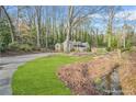 A picturesque home nestled in a natural landscape with lush greenery and a quaint creek running through the property at 437 Westmeath Sw Dr, Atlanta, GA 30310