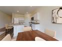 Cozy kitchen with white cabinets, stainless steel appliances, and barstool seating at 7717 Sudbury Cir, Covington, GA 30014