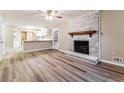 Spacious living room featuring wood-look floors and a whitewashed brick fireplace at 3119 Windfield Cir, Tucker, GA 30084