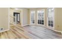 Sun-drenched living room with stylish wood-look floors and staircase at 3119 Windfield Cir, Tucker, GA 30084
