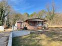 Exterior view of a charming home with a brick facade and well-kept lawn at 8859 Thomas Rd, Jonesboro, GA 30238