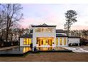 Back exterior featuring sleek black trim, backyard pool, outdoor lounge area, and a covered patio perfect for entertaining at 185 Pebble Trl, Alpharetta, GA 30009