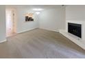 Spacious living room featuring a cozy fireplace and neutral color palette at 6090 Wintergreen Rd # 1A3, Norcross, GA 30093