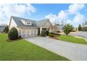 Well-maintained home with lush green lawn, concrete driveway and attached two car garage at 164 Owens Farm Ln, Woodstock, GA 30188