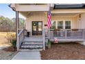 Inviting front porch with double doors, stone stairs, and classic decor at 1721 Mcgarity Rd, Temple, GA 30179