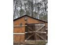 Image of an old wooden barn with double doors at 5435 Hearn Rd, Ellenwood, GA 30294